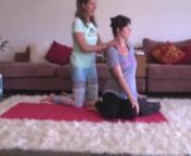 Bliss Baby Yoga Director, Ana Davis, adjusts Sophie, 28 weeks pregnant, in a safe prenatal twist—Bharadvajasana (The Sage Pose).