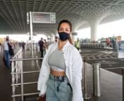 Malaika Arora teams an oversized open shirt with a sports bra and cropped denim pants at the airport. Adds a pop of colour with an orange duffle accessory. The fab at 47 actress got clicked at the airport as she heads out of the city to celebrate Christmas. Malaika looked stunning as ever as she opted for an uber-chic style statement for the airport look in majority white. Taking a flight was another chiselled hunk of Bollywood, John Abraham, who too chose white for the day. Keeping it casual, t