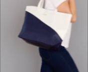 4660nStray from the popular black hand bag and go to work in style with our large personalized color block faux leather tote bag. This custom vegan leather tote bag may be priced cheap, but its features are anything but. It is available in chic shades of navy blue, blush pink, and white, is fully lined, features a small snap magnet closure, and long handles you can sling over your shoulder. The large proportions make this reusable tote bag handy for anything from travel, taking books to school,