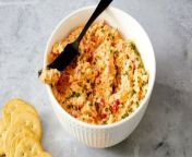 Loaded with shredded cheddar and diced peppers, this soft and creamy pimento cheese dip is perfect for spreading on everything from crackers to veggies.