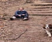 This dog got the zoomies while out for a walk with their owner. When the dog dashed down the hill, their leash got stuck in the owner&#39;s foot, causing her to lose balance and fall immediately.